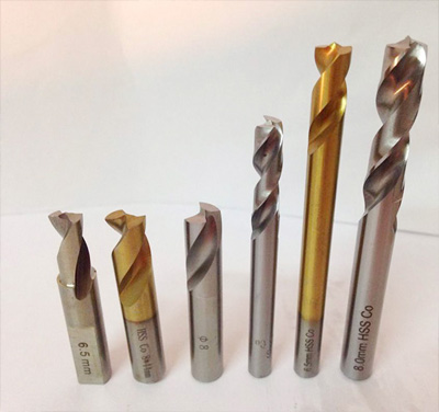 How are commonly used bits for machining produced?